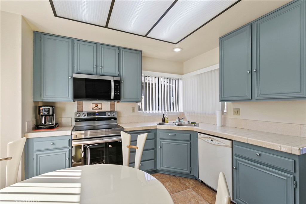 51 Rainbow Irvine, CA 92603 - Photo 9 of 25 a kitchen with a sink stove and microwave