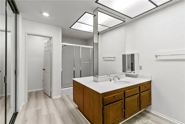 a bathroom with a sink a mirror and a shower