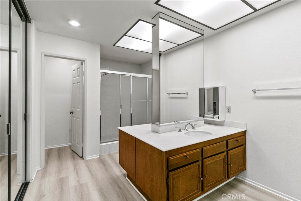 51 Rainbow Irvine, CA 92603 - Photo 10 of 25 a bathroom with a sink a mirror and a shower