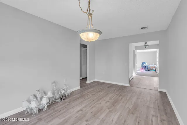 a view of a room with wooden floor