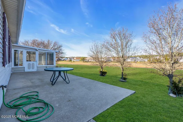 a view of a house with backyard and a sitting area