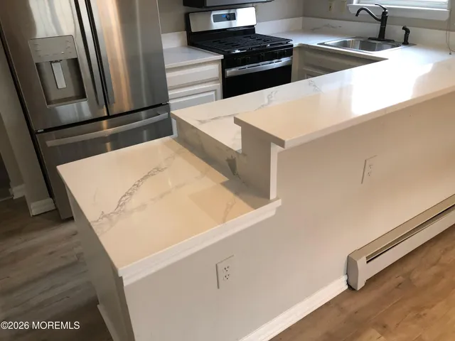 a kitchen with stainless steel appliances a stove and a refrigerator
