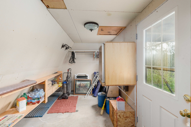 23 Scare Canyon, Unit 23 Logan, UT 84321 - Photo 19 of 33 Utility room featuring built-in shelving, concrete flooring, and a windowed exterior door