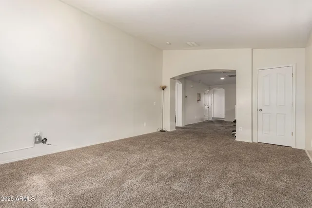 an empty room with furniture and a window