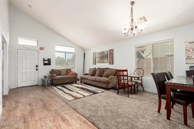 a living room with furniture and a chandelier