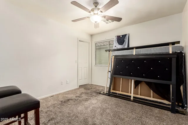 a view of a livingroom with furniture and chandelier fan