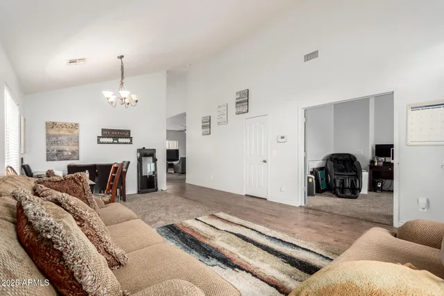 a living room with furniture chandelier and couches