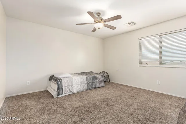 a view of empty room with ceiling fan