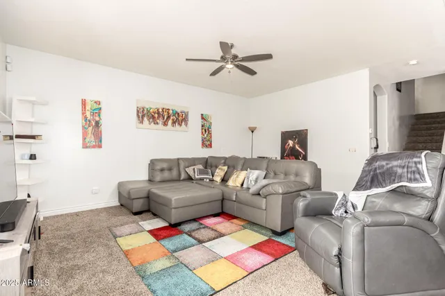 a living room with furniture and a rug