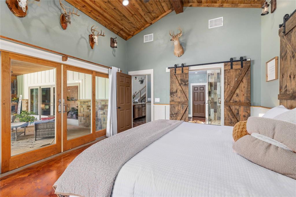 1601 County Road 156 Bangs, TX 76823 - Photo 17 of 40 a spacious bedroom with a large bed and a large window