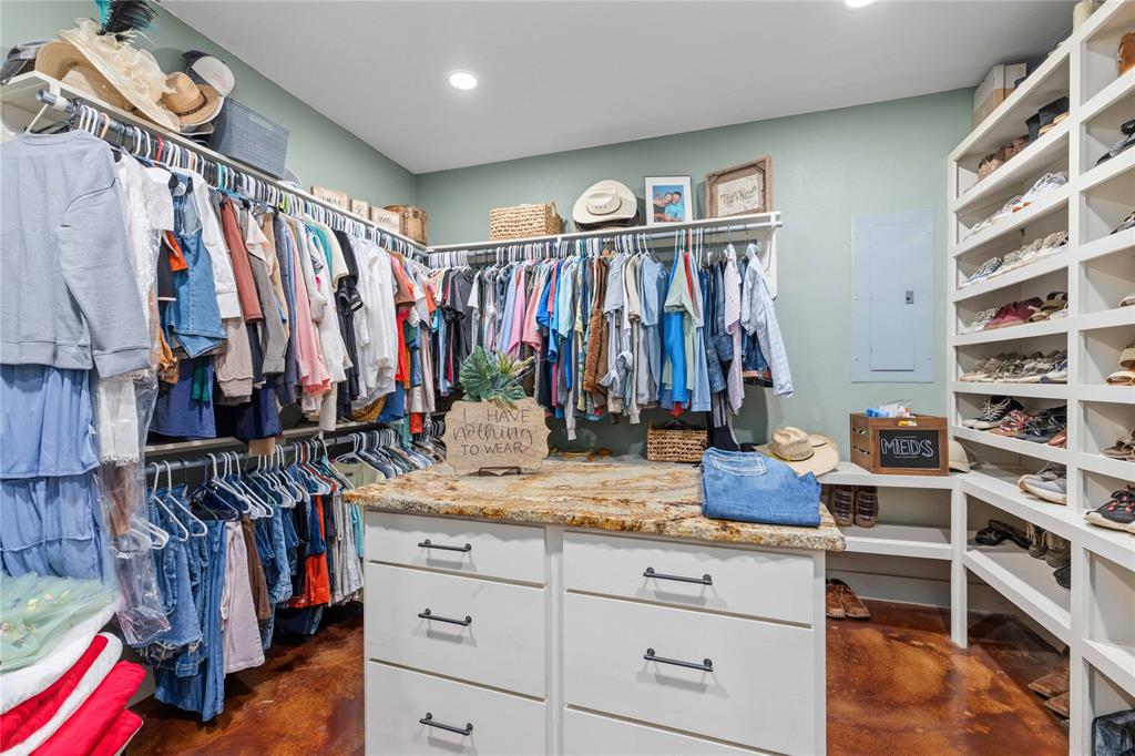 1601 County Road 156 Bangs, TX 76823 - Photo 19 of 40 a view of walk in closet with clothes and shoes