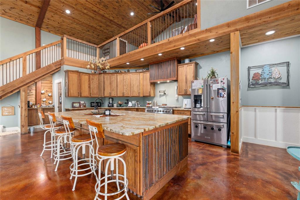 1601 County Road 156 Bangs, TX 76823 - Photo 3 of 40 a large kitchen with stainless steel appliances granite countertop a stove and cabinets