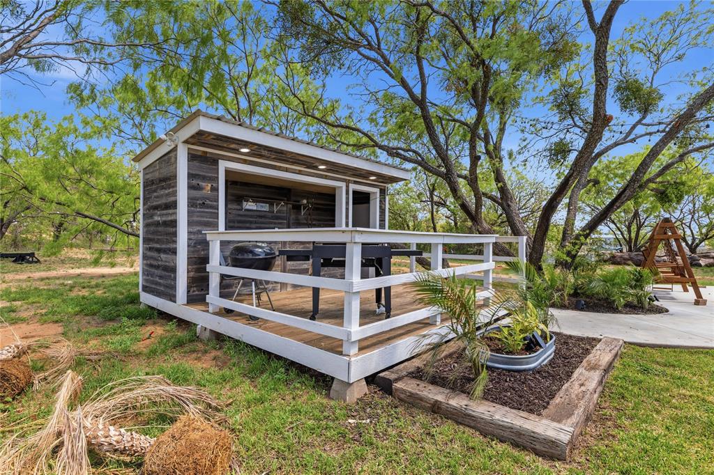 1601 County Road 156 Bangs, TX 76823 - Photo 35 of 40 a view of house with a yard from a large tree