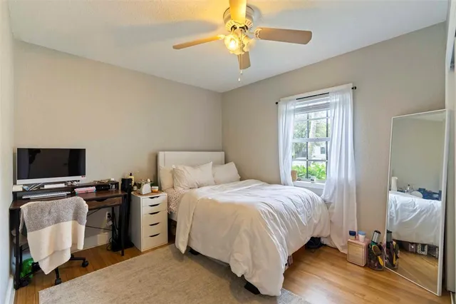 a bedroom with a bed and a chandelier