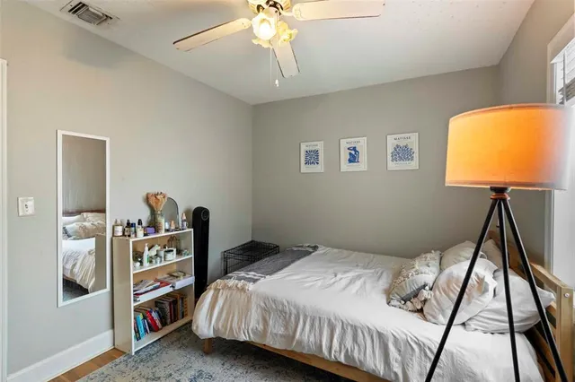 a bedroom with a bed and a bookshelf