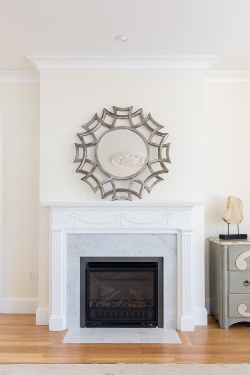 26 Parker Street Cambridge, MA 02138 - Photo 12 of 29 a living room with a fireplace and wooden floor