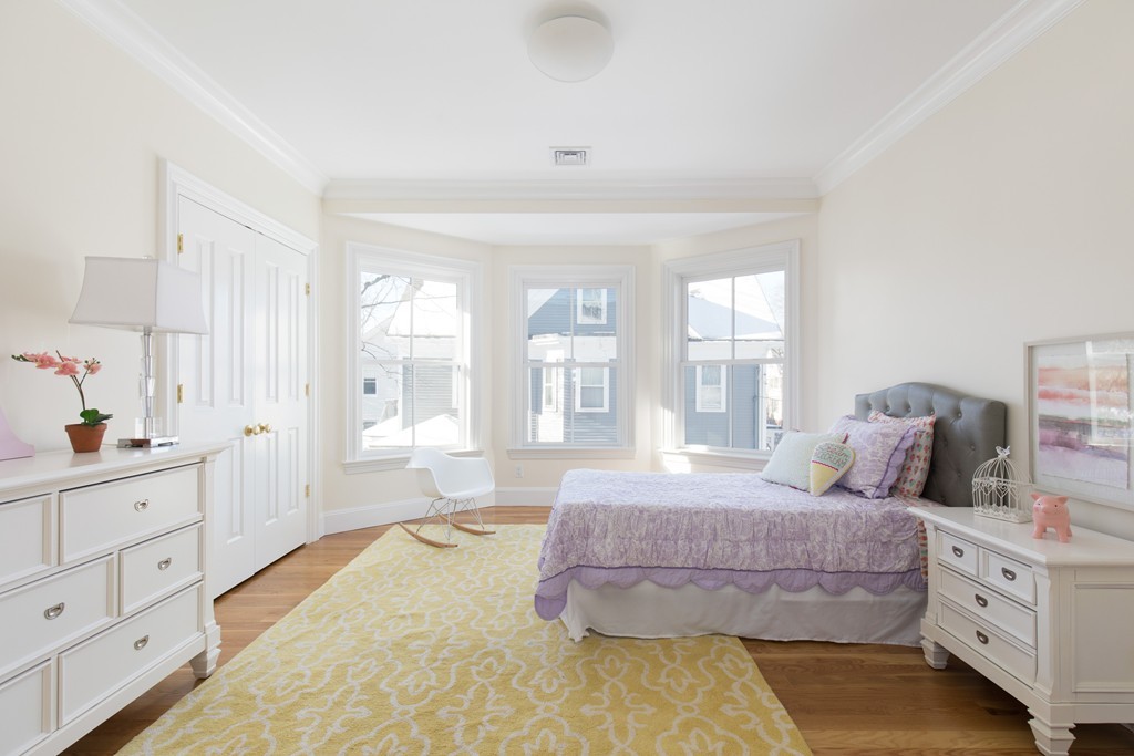 26 Parker Street Cambridge, MA 02138 - Photo 20 of 29 a spacious bedroom with a bed and a dresser
