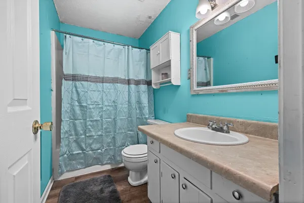 a bathroom with a sink toilet and shower