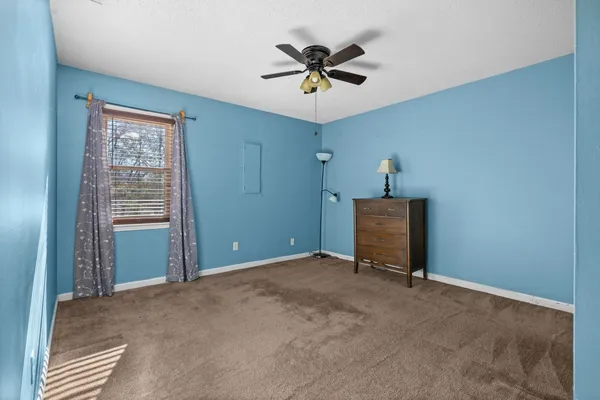 a view of room with window and ceiling fan