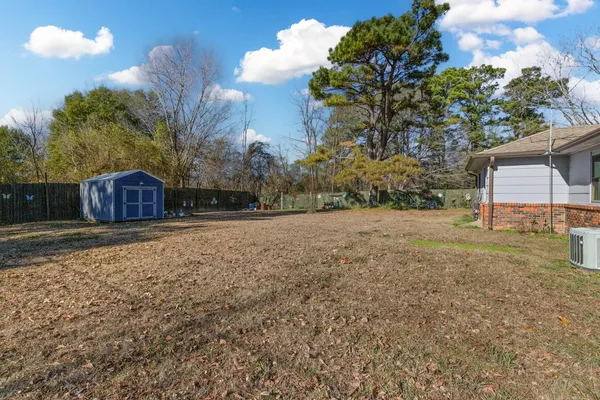 a view of a backyard with large trees