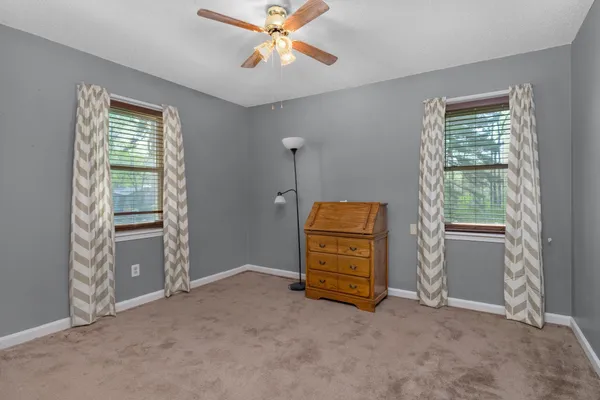 a view of room with window and a ceiling fan