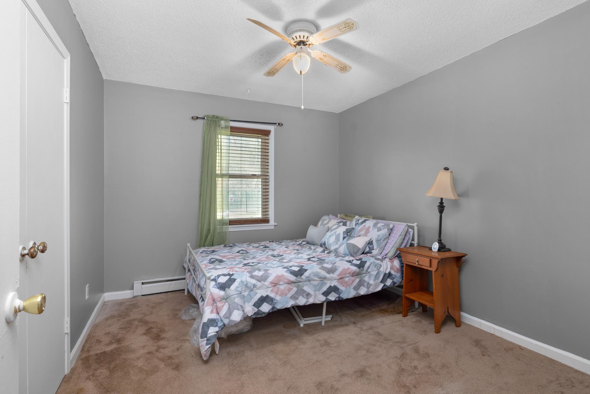 163 Michelle Street Burlison, TN 38015 - Photo 8 of 13 a bedroom with a bed and a chandelier