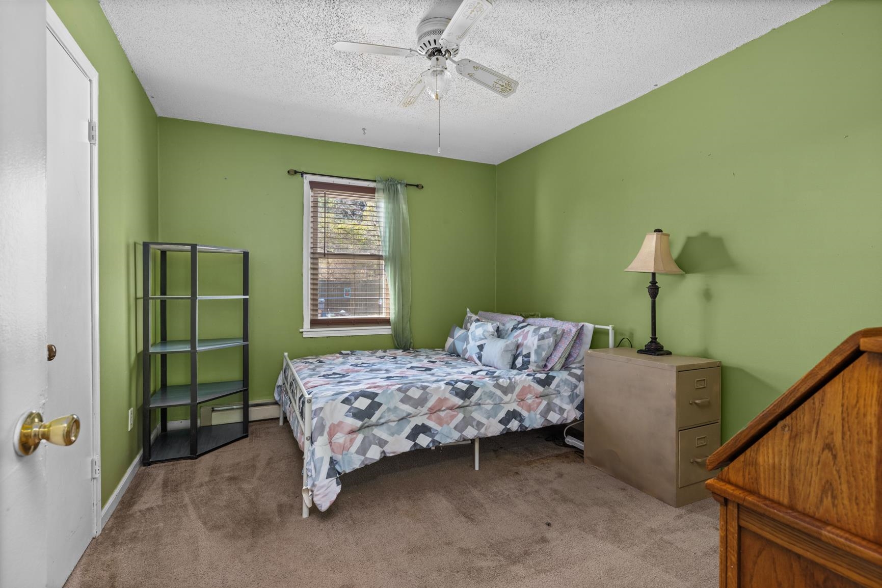 163 Michelle Street Burlison, TN 38015 - Photo 10 of 13 a bedroom with a bed and a chandelier