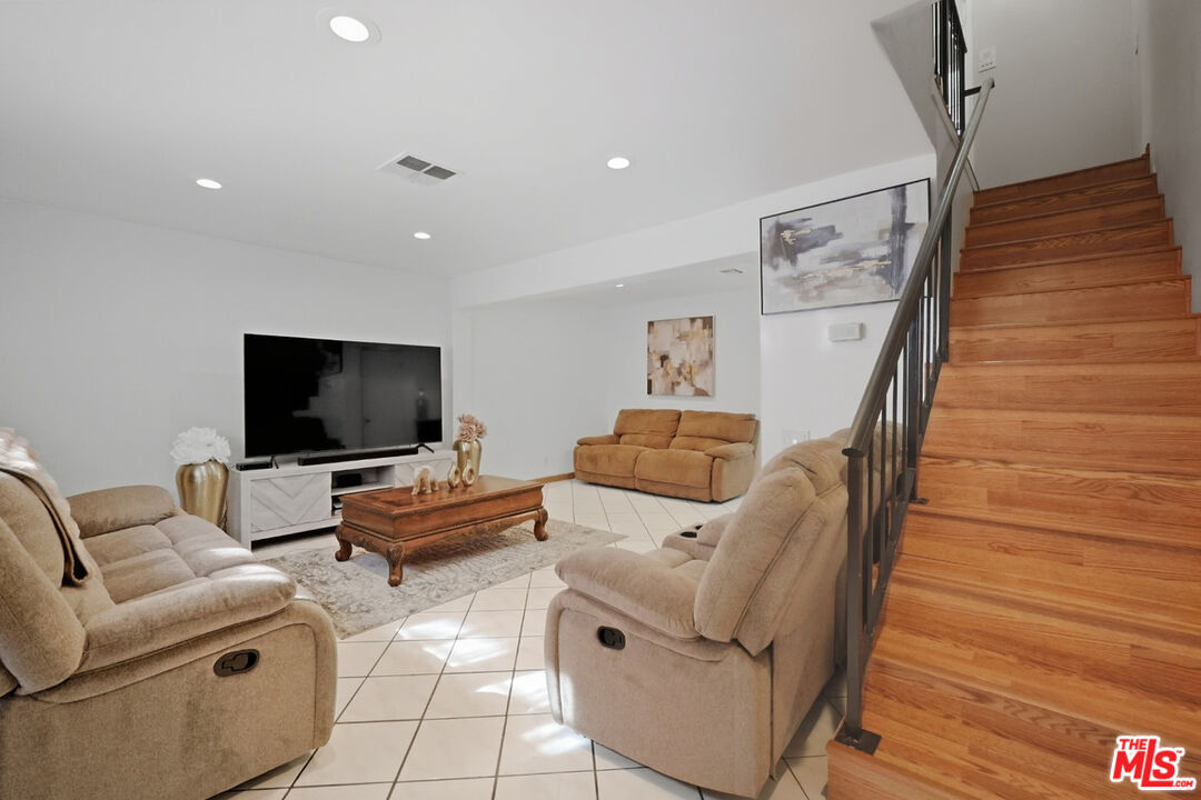 7422 Hazeltine Avenue, Unit 3 Van Nuys, CA 91405 - Photo 1 of 36 a living room with furniture and a flat screen tv
