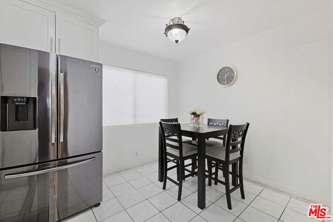 7422 Hazeltine Avenue, Unit 3 Van Nuys, CA 91405 - Photo 12 of 36 a view of a dining room with furniture and a refrigerator