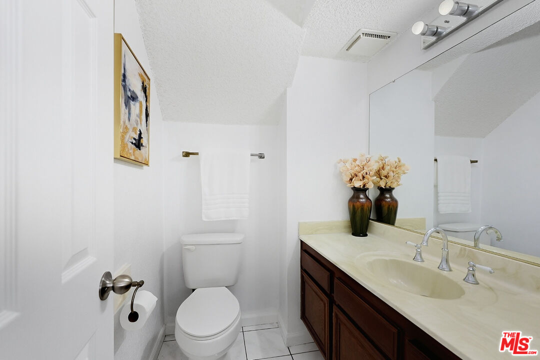7422 Hazeltine Avenue, Unit 3 Van Nuys, CA 91405 - Photo 14 of 36 a bathroom with a toilet sink and mirror