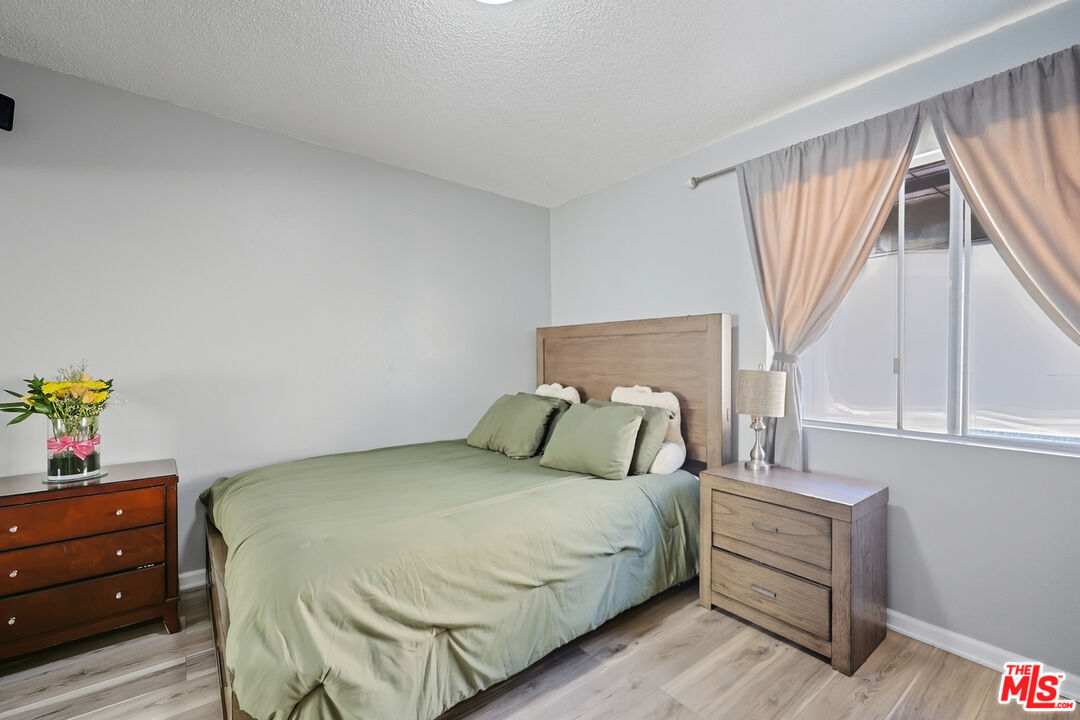 7422 Hazeltine Avenue, Unit 3 Van Nuys, CA 91405 - Photo 16 of 36 a bedroom with a bed and a window