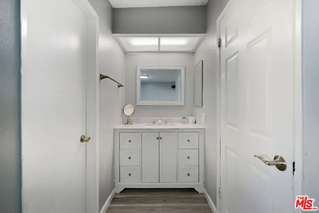 a bathroom with a granite countertop sink a toilet and a mirror