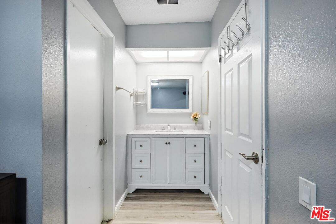7422 Hazeltine Avenue, Unit 3 Van Nuys, CA 91405 - Photo 19 of 36 a bathroom with a sink and a mirror