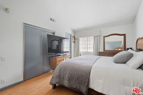 a bedroom with a bed and with furniture