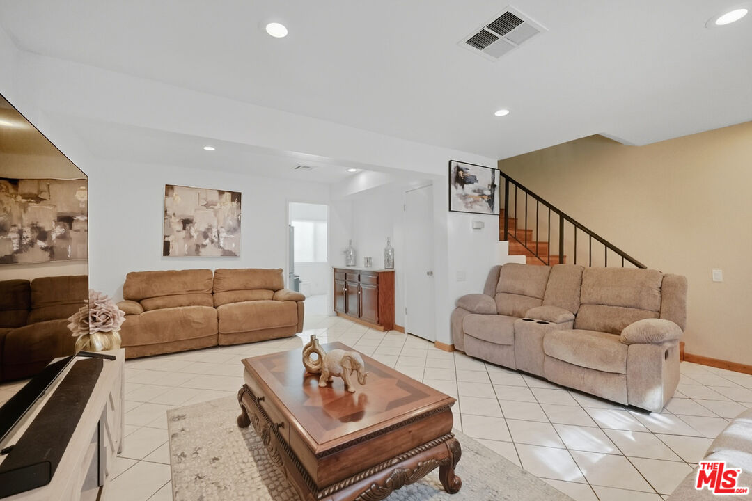 7422 Hazeltine Avenue, Unit 3 Van Nuys, CA 91405 - Photo 2 of 36 a living room with furniture and a rug