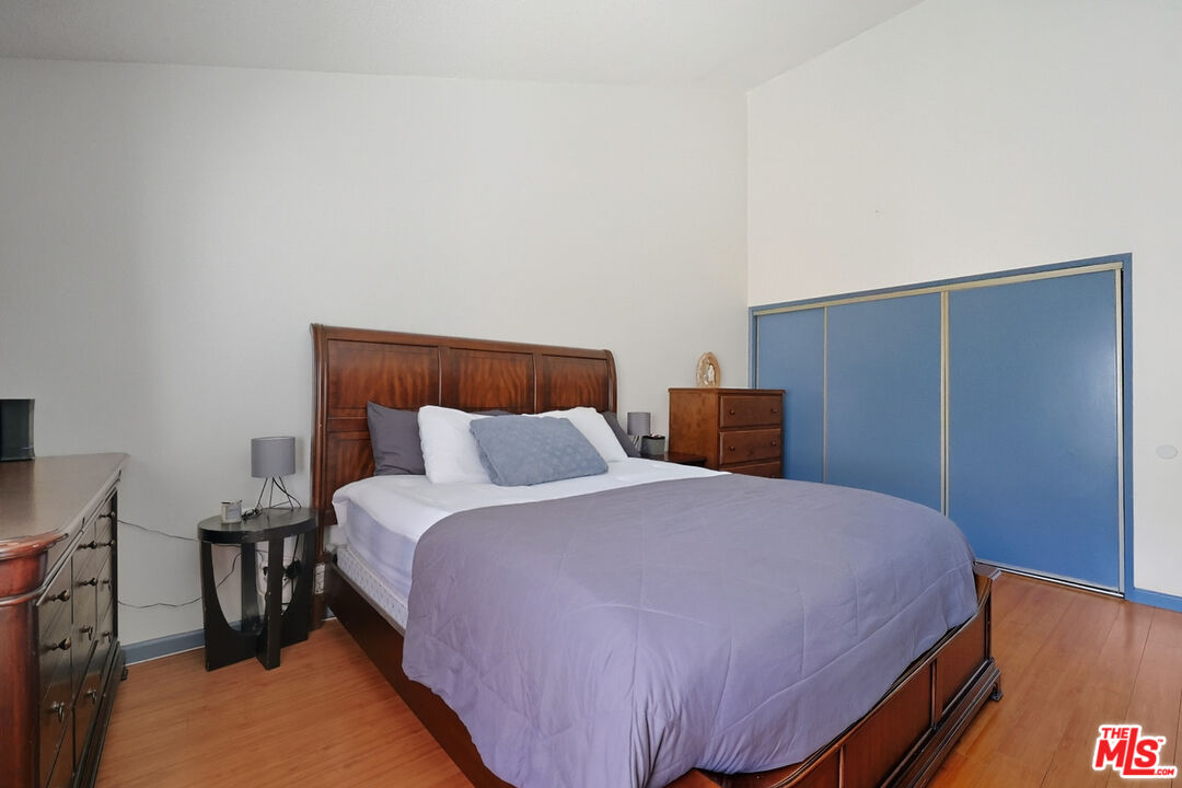 7422 Hazeltine Avenue, Unit 3 Van Nuys, CA 91405 - Photo 22 of 36 a bedroom with a bed and wooden floor