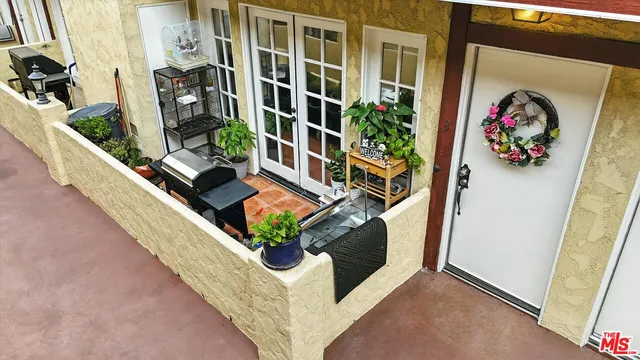 a building outdoor space with patio furniture and potted plants