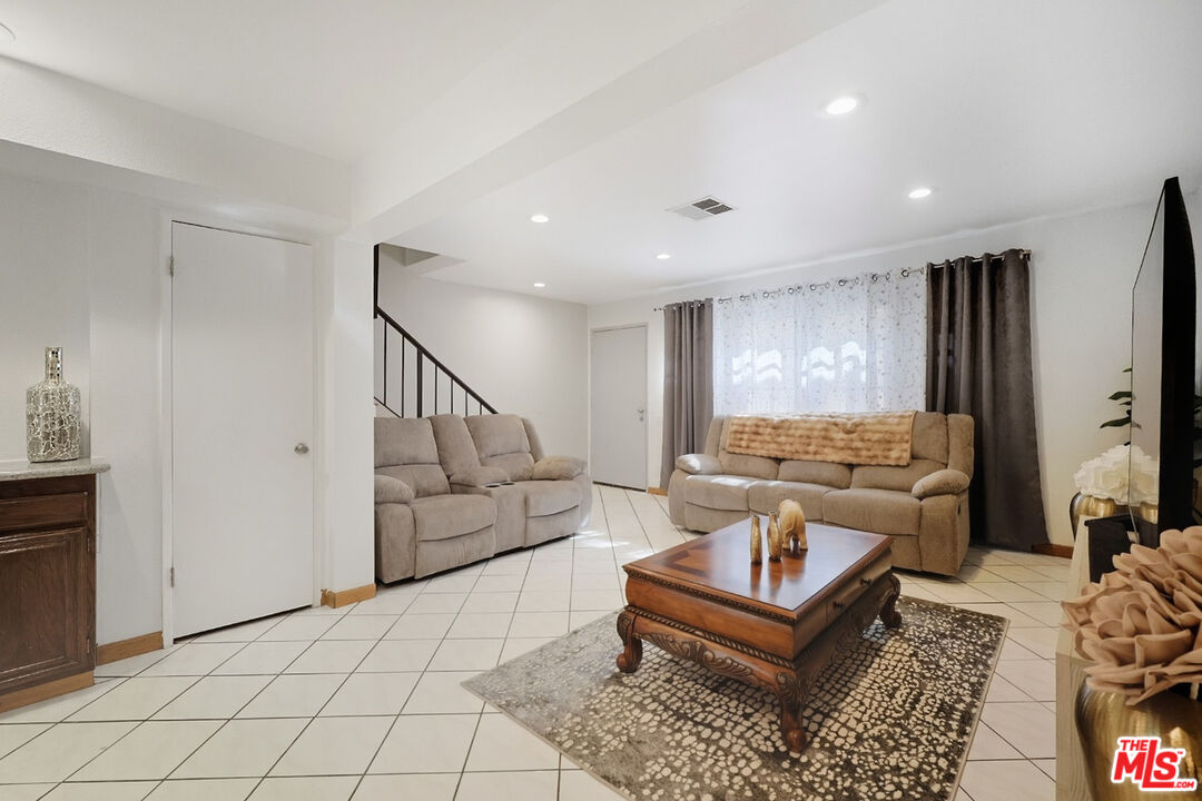 7422 Hazeltine Avenue, Unit 3 Van Nuys, CA 91405 - Photo 4 of 36 a living room with furniture and a table