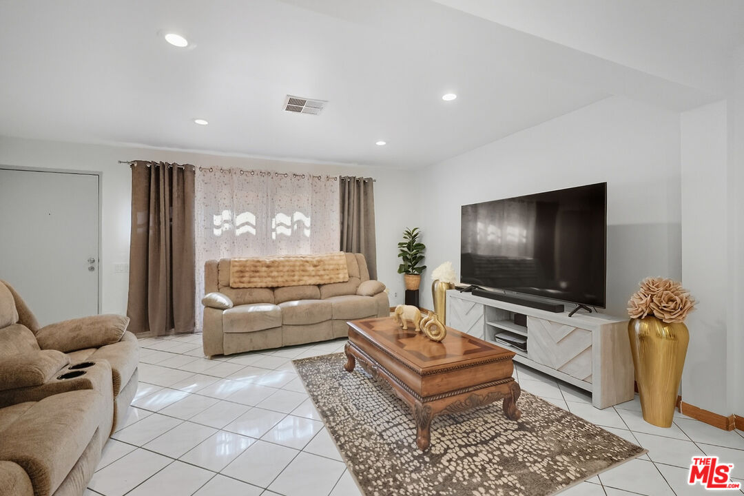 7422 Hazeltine Avenue, Unit 3 Van Nuys, CA 91405 - Photo 6 of 36 a living room with furniture and a flat screen tv