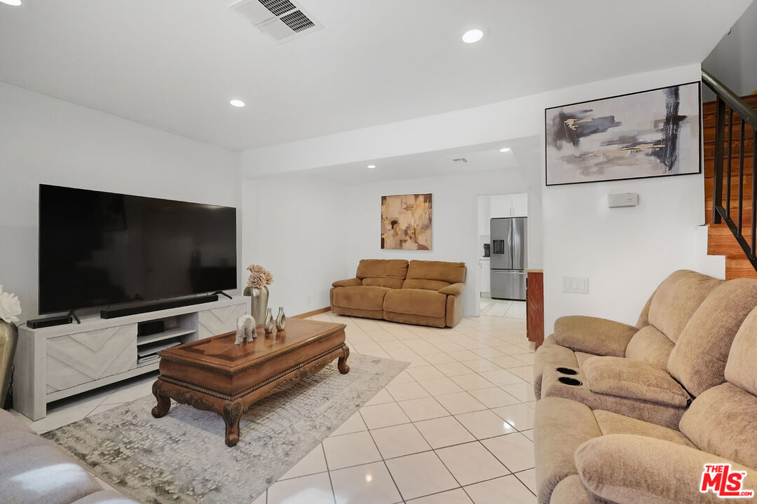 7422 Hazeltine Avenue, Unit 3 Van Nuys, CA 91405 - Photo 7 of 36 a living room with furniture and a flat screen tv