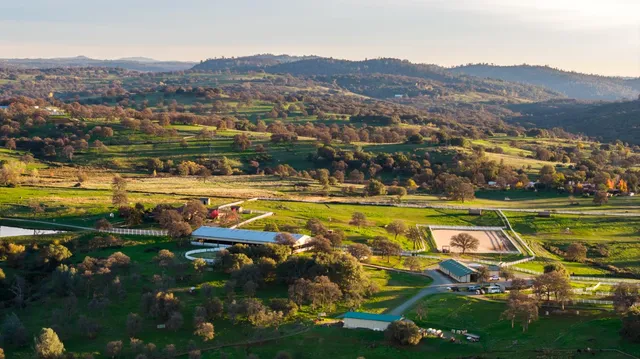 a view of swimming pool with outdoor seating and a garden