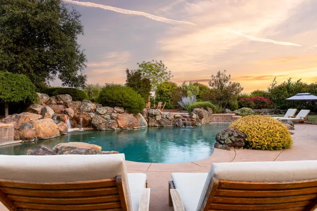 a view of a swimming pool and a yard