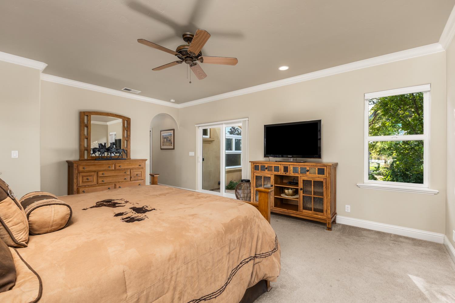 20945 Bear Hollow Road Grass Valley, CA 95949 - Photo 51 of 82 a bedroom with a bed and a flat screen tv