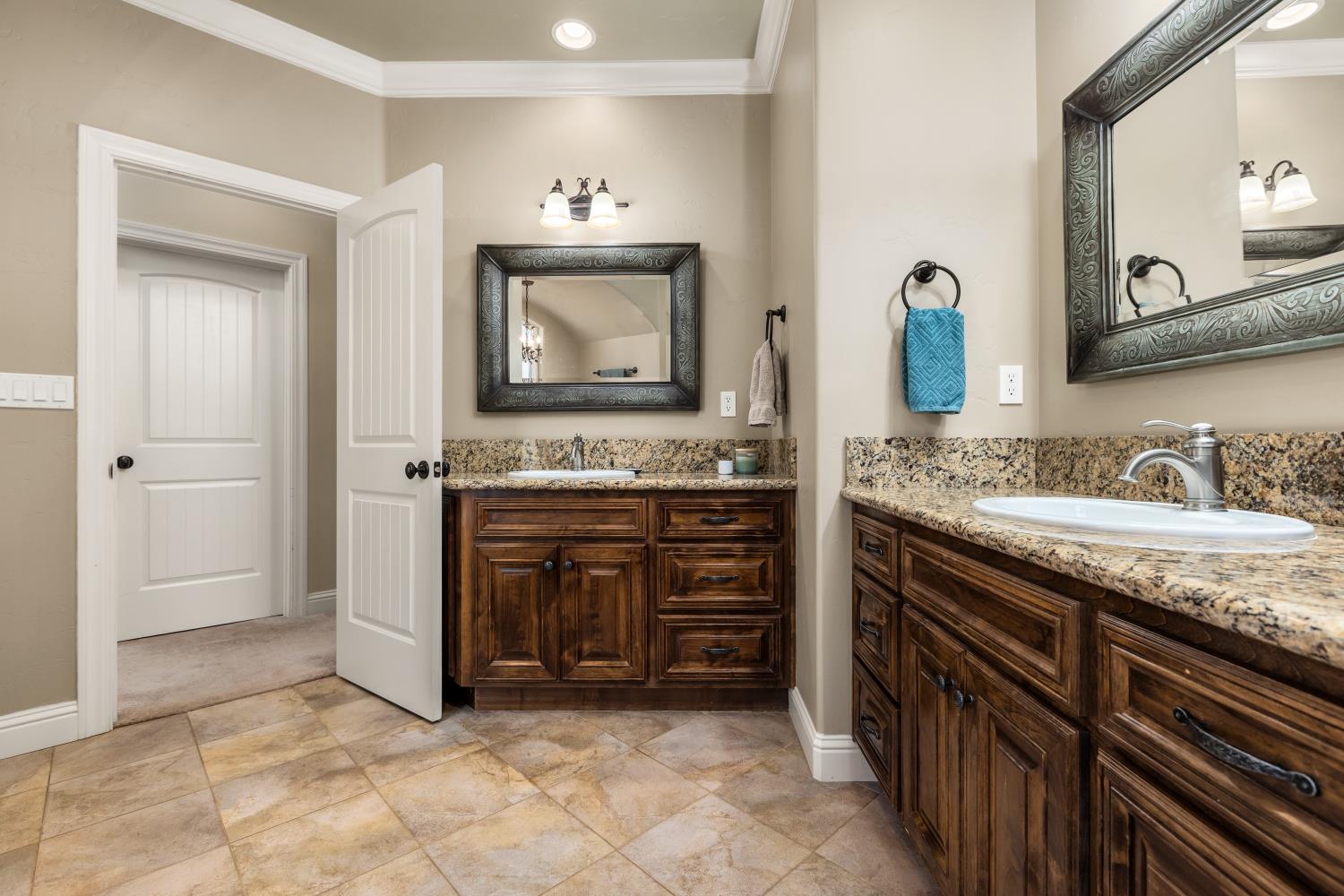 20945 Bear Hollow Road Grass Valley, CA 95949 - Photo 55 of 82 a spacious bathroom with a granite countertop sink and a mirror