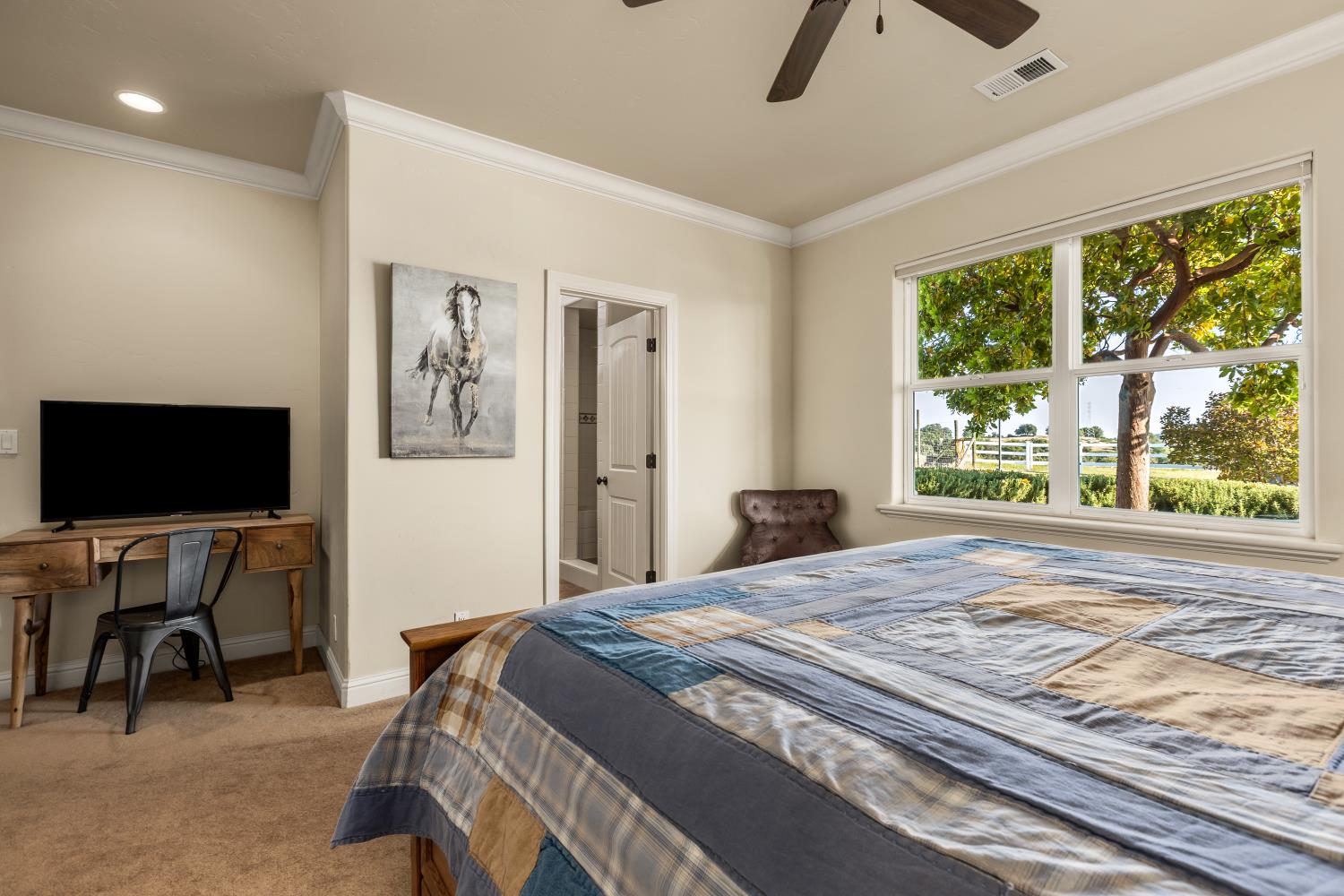 20945 Bear Hollow Road Grass Valley, CA 95949 - Photo 61 of 82 a bedroom with a bed a flat screen tv and a large window