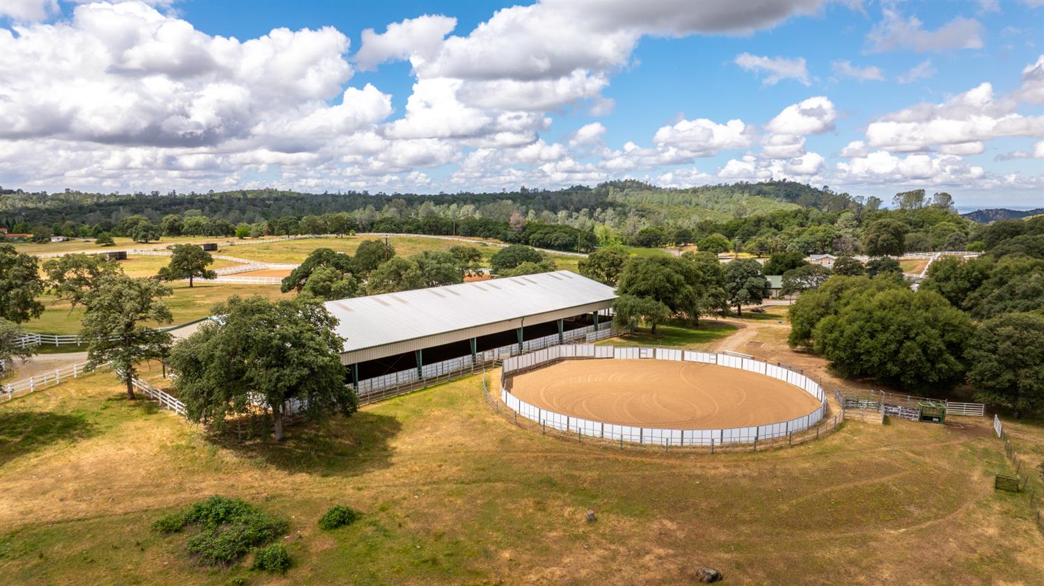 20945 Bear Hollow Road Grass Valley, CA 95949 - Photo 8 of 82 an aerial view of a house with swimming pool and mountains in the background
