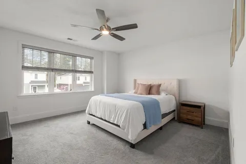 a bed sitting in a bedroom next to a window