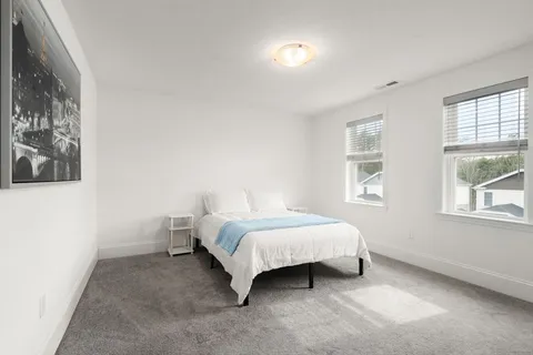 a bedroom with a bed and window