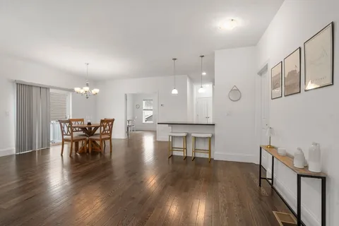 a view of a dining room with furniture and wooden floor