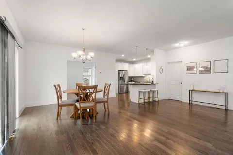 a dining room with furniture and wooden floor